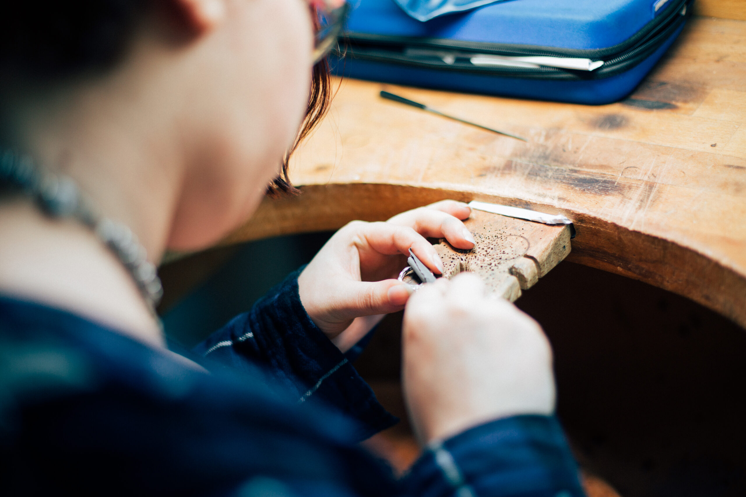 Student filing a ring at work bench- Graff Live Project